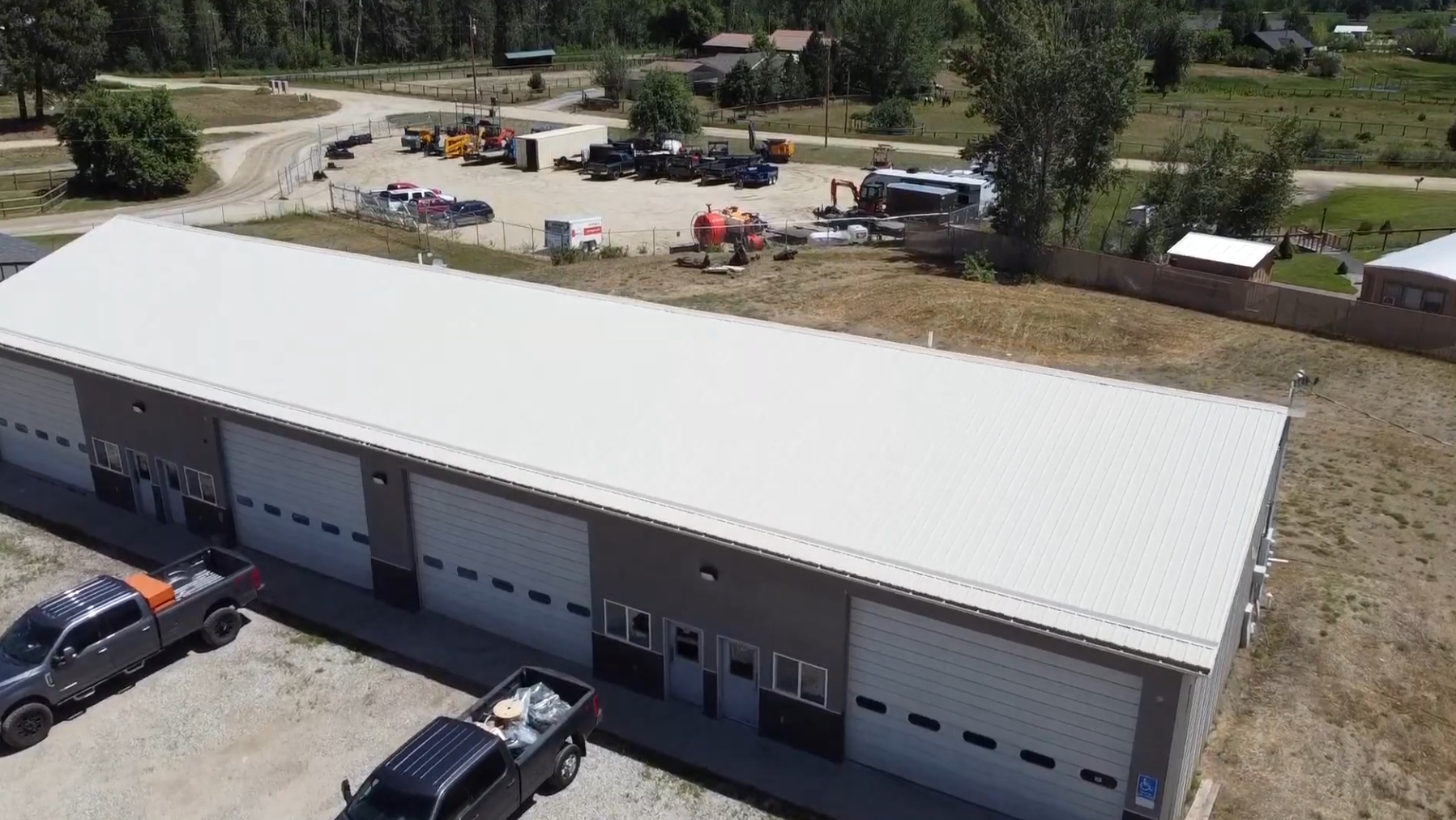 Aerial view showing the fenced yard sitting directly behind the flex buildings at Bitterroot Industrial Park.