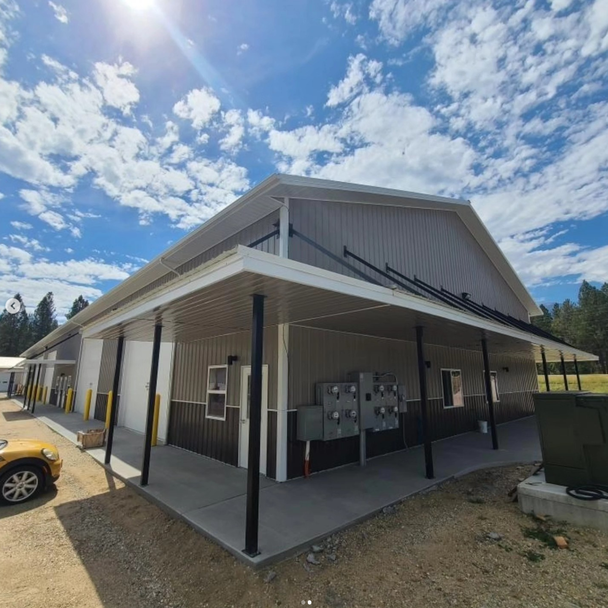 A run of adjoining units under a covered walkway, each with its own entry door and electrical meter.